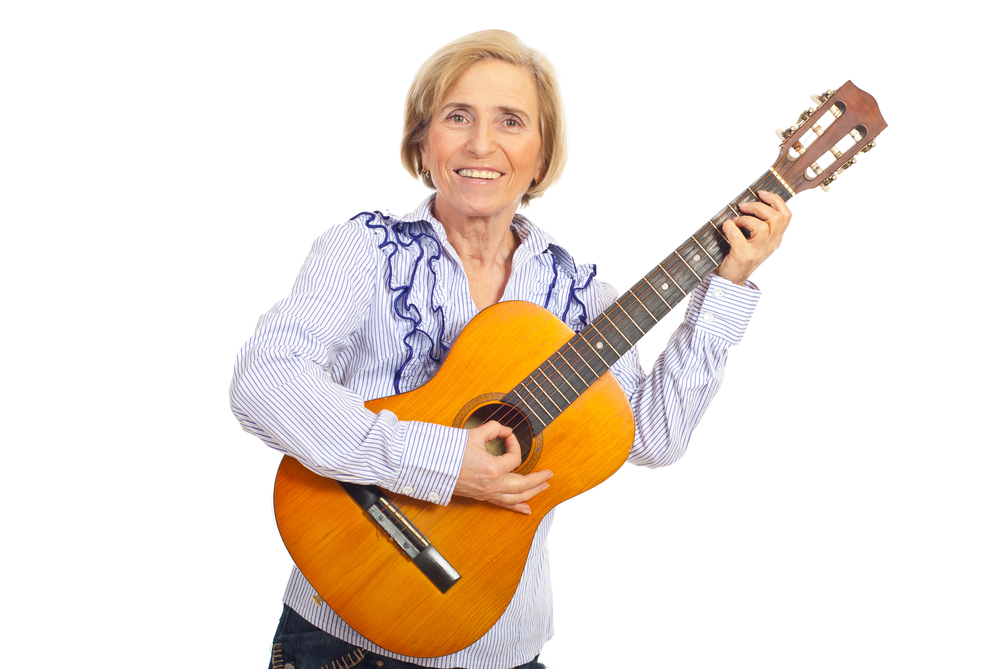 mature woman playing a guitar.jpg